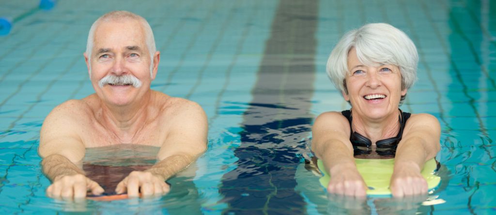 happy senior couple in swimming pool