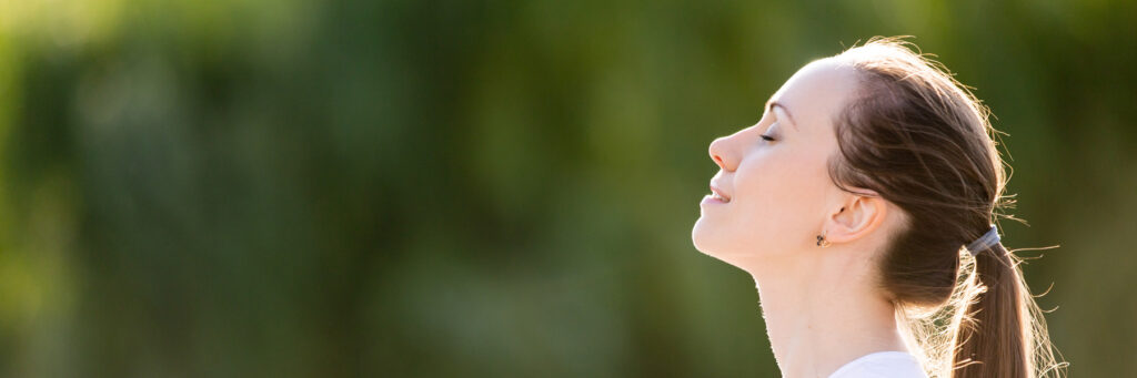 Horizontal conceptual photo profile portrait relaxed woman face closed eyes breath fresh clean air outdoors enjoying nature weather feels good banner for website header design with copy space for text.