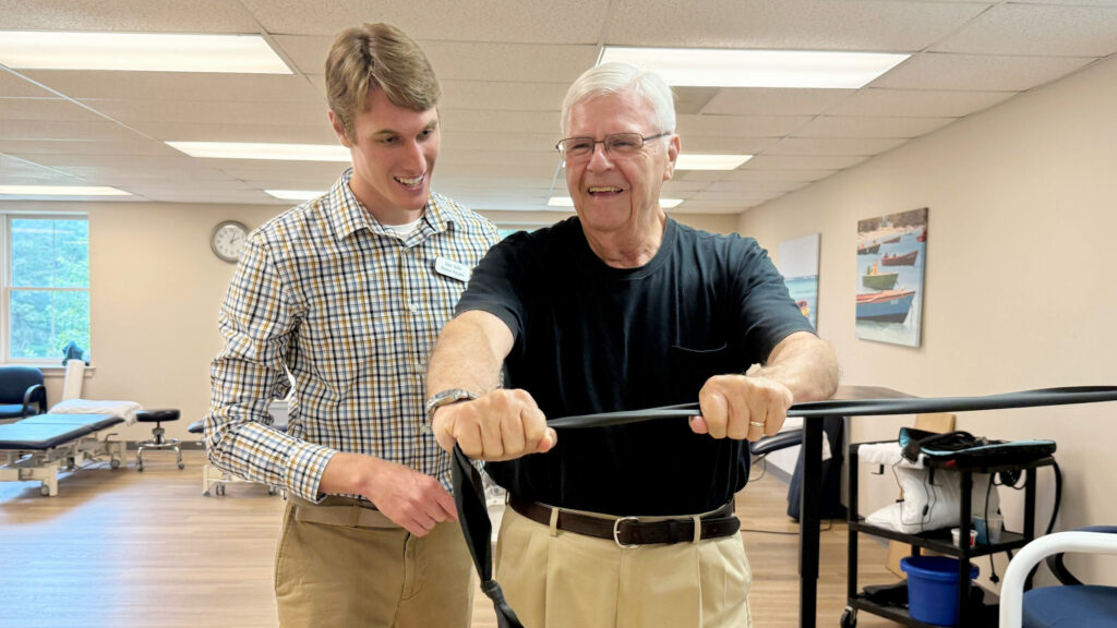 Dain helping patient with strength