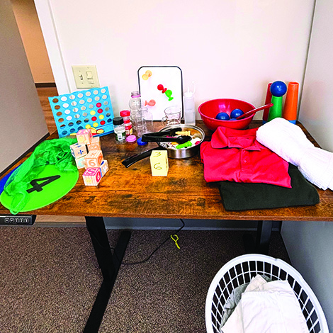 Table with various colorful objects for gross motor skills