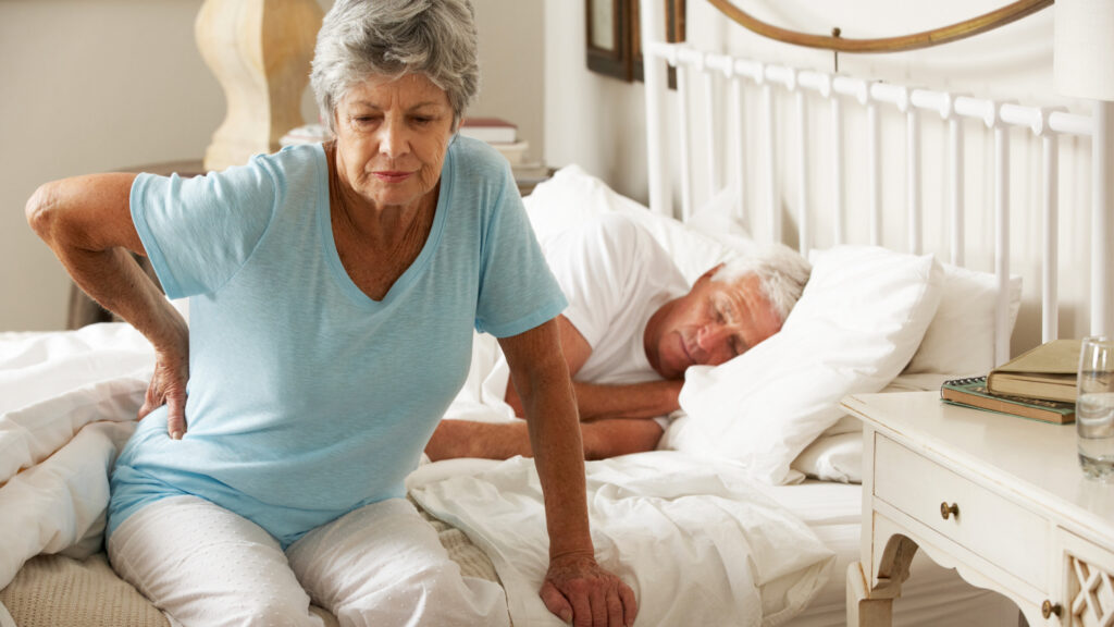 Elderly woman experiencing back pain