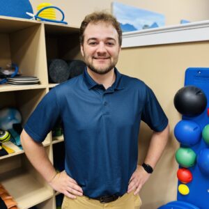 Smiling man in a blue polo
