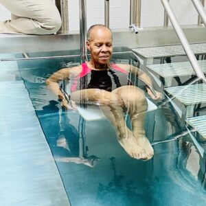 Person in pool using therapy equipment
