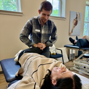 man stretching older woman